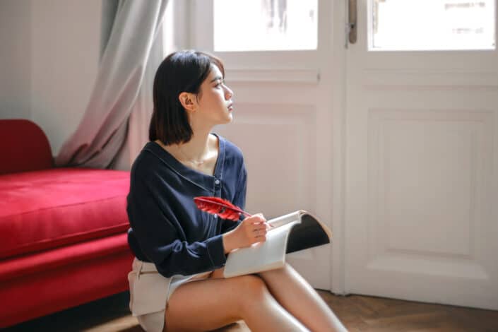 Woman thinking on what to write 
