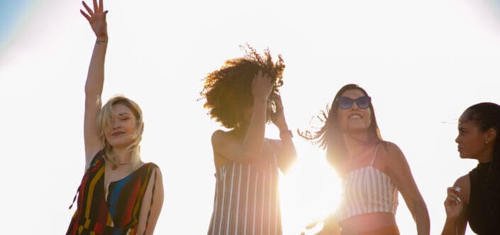 Women delightedly waving