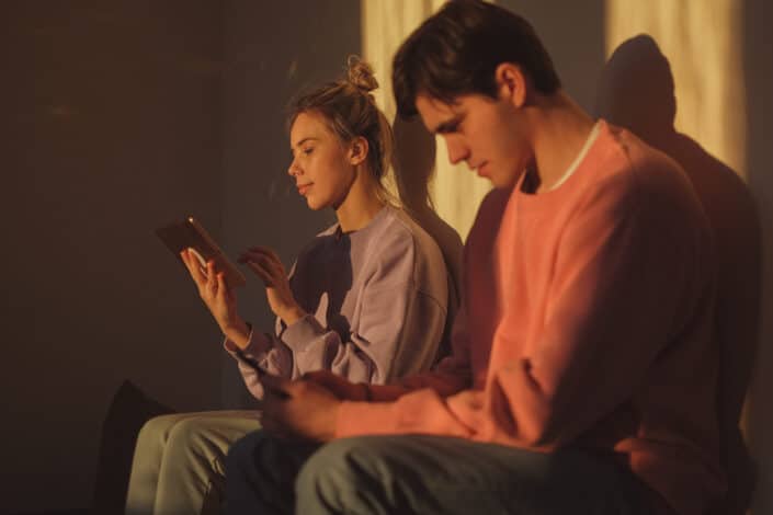 Couple Using Tablet and Phone