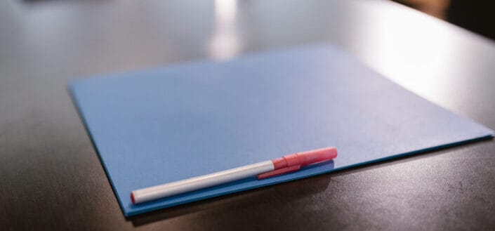 pen and folder in a table
