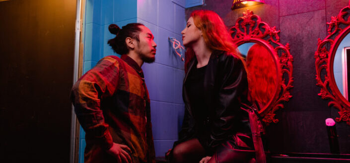 couple Facing Each Other at the Restroom