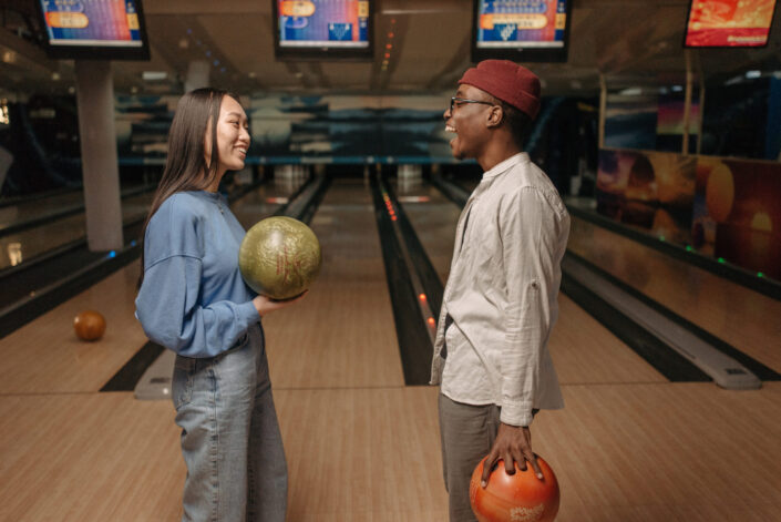 friends Holding Bowling Ball while Talking