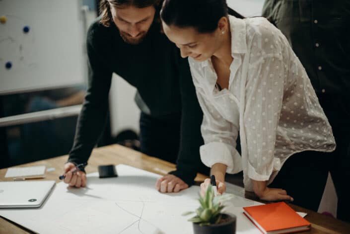 colleagues Staring at White Board Having a Meeting