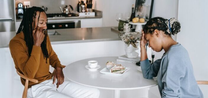 Couple arguing at kitchen table