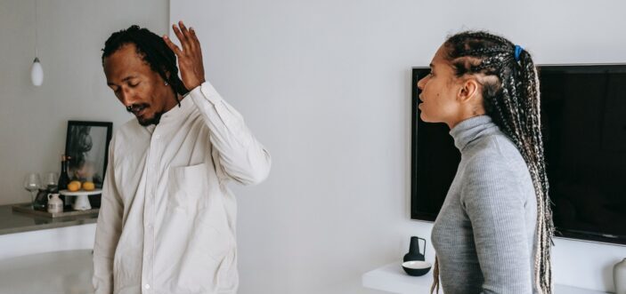 A man waving off his girlfriend.