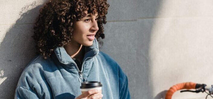 A woman with cup of takeaway coffee.