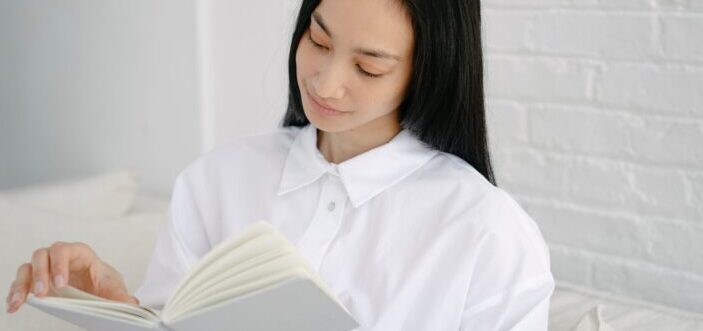 Woman flipping page of book.