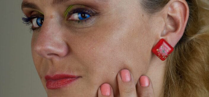 Woman Wearing Red Dress Holding Her Face
