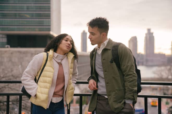 Couple talking while leaning on the rail - Awkward questions to ask a guy
