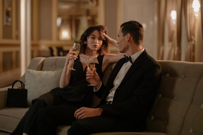 Couple in formal attire talking while drinking