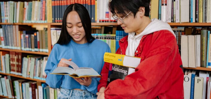Man and woman busy reading book