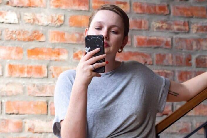 Brown haired woman looking at her phone