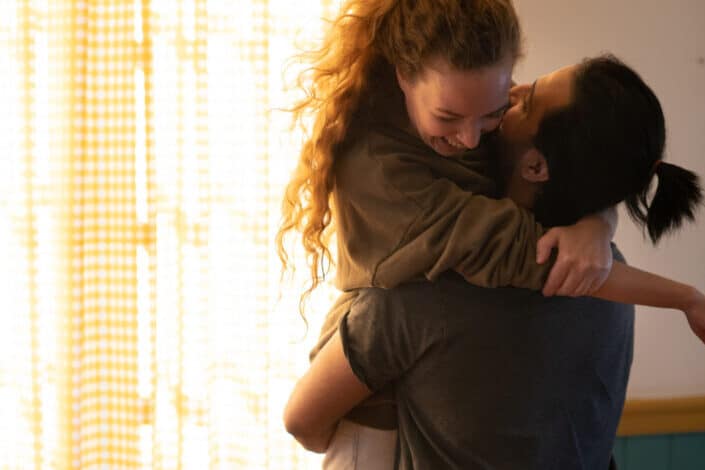 Woman being carried by her excited man