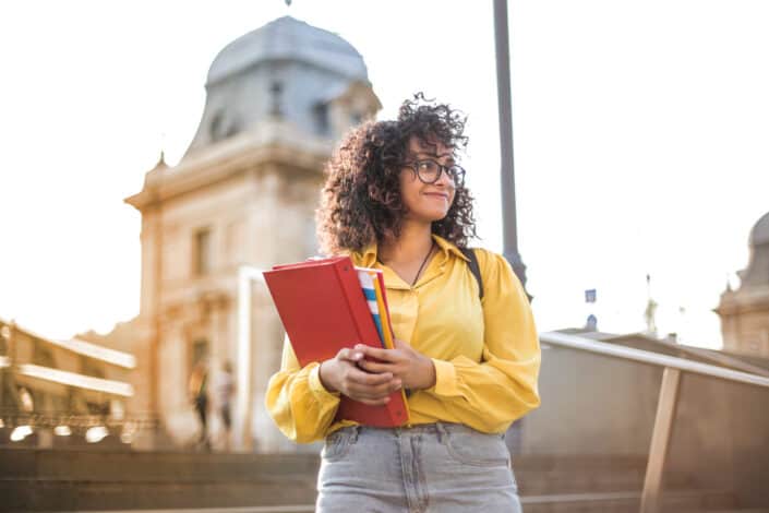 Woman posing in front of school