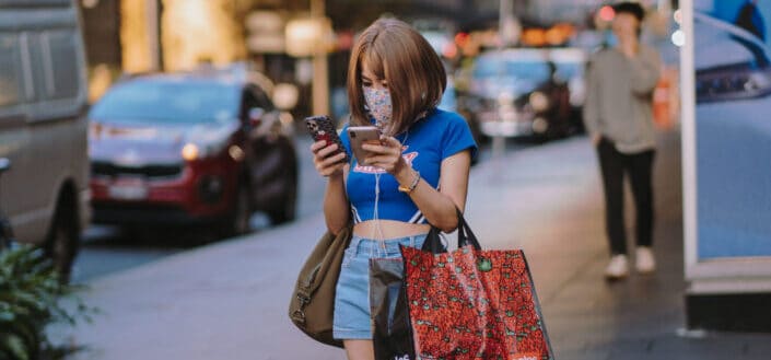Short haired woman using two phones