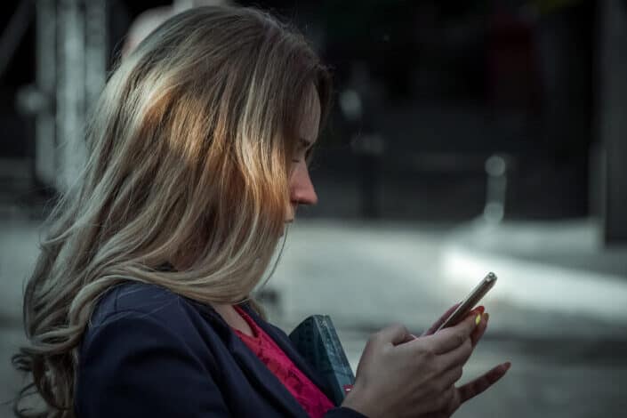 Blonde woman staring at her phone