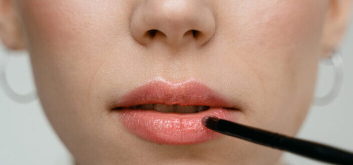 Woman putting lipsticks