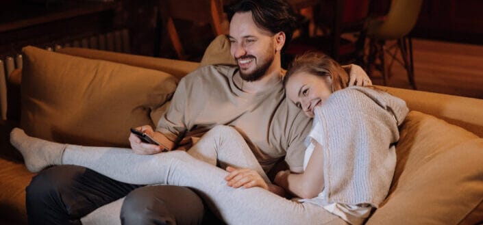 Couple watching while sitting on the couch