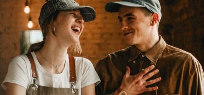 Couple both wearing caps having happy talks