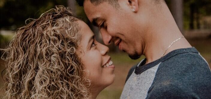A man and woman smiling at each other