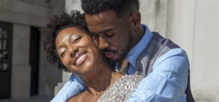 man hugging his woman from behind