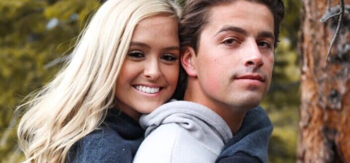 couple wearing hoodies and hugging