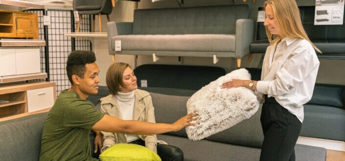 Sales lady showing customers a fluffy pillow