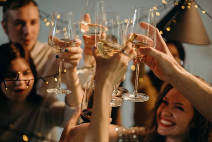 Several People Cheering Wine Glasses