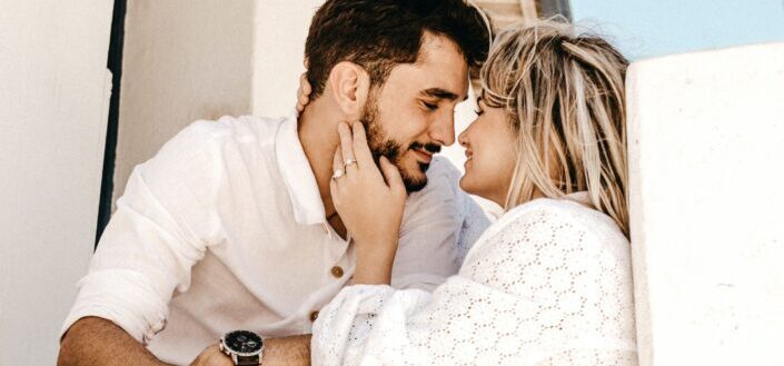 smiling man and woman about to kiss