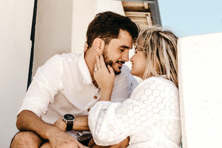 Couple getting cozy and about to kiss.