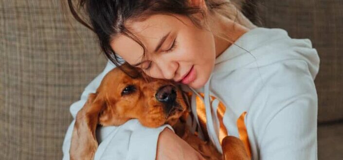 Woman hugging her dog adorably
