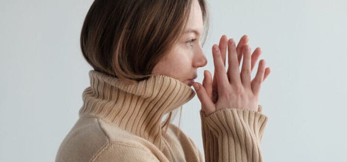 girl in a sweater thinking