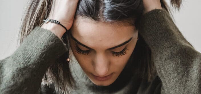 stressed girl wearing a gray sweater