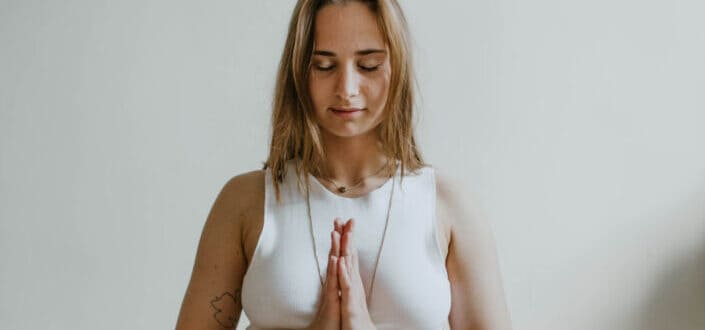 blonde girl praying with her eyes close