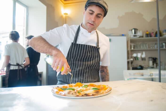 A man making a pizza.