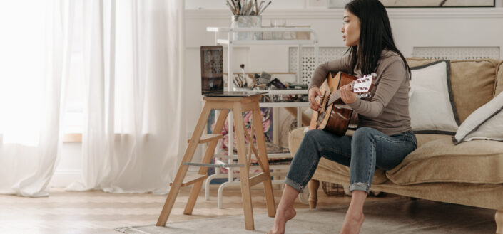 Woman Learning How to Play a Guitar