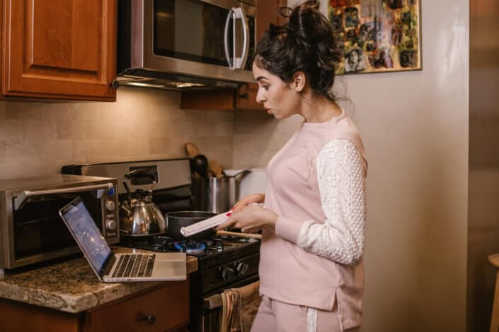 woman cooking while having videocall