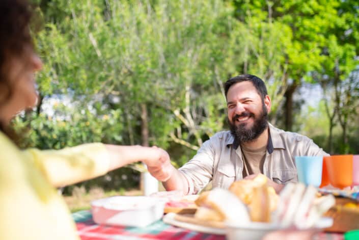 Couple holding hands while having a snack together