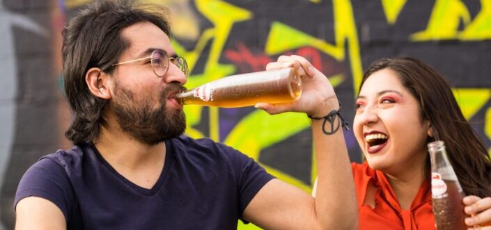 Couple laughing while drinking soda.