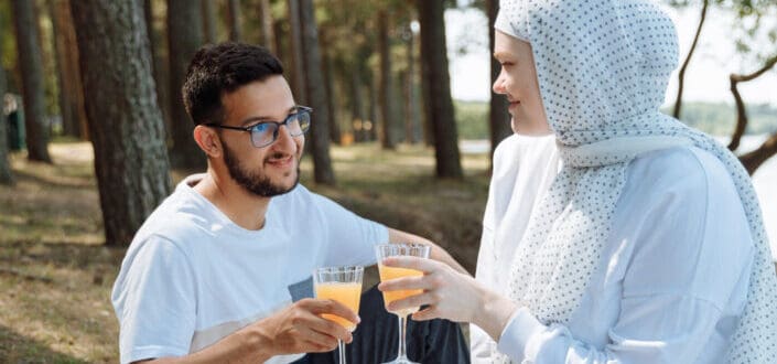 Couple on a picnic date in the woods.