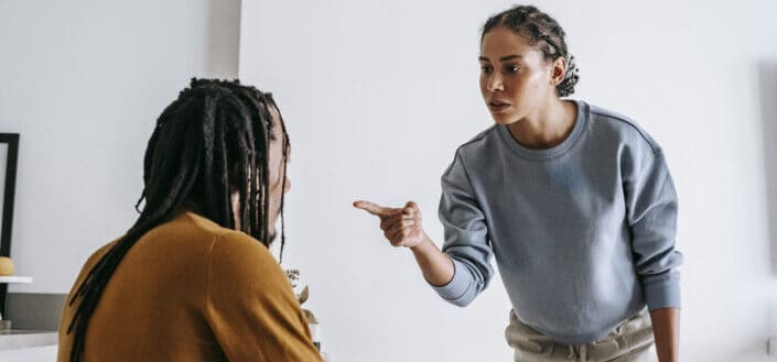Woman pointing at man while arguing