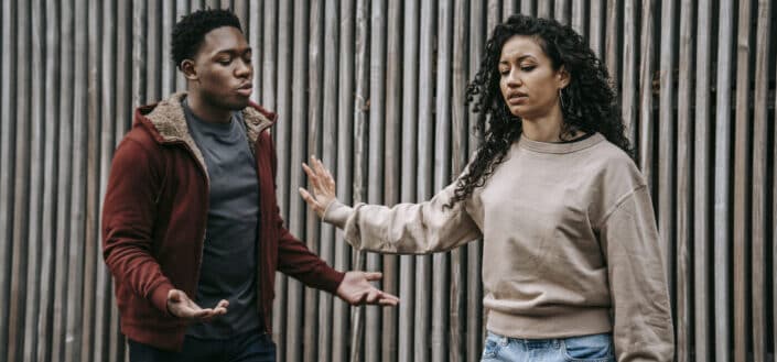 multiethnic couple having conflict on street