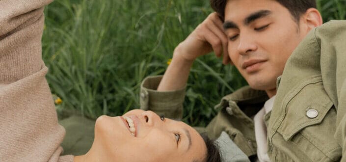 Man admiring woman looking up at sky