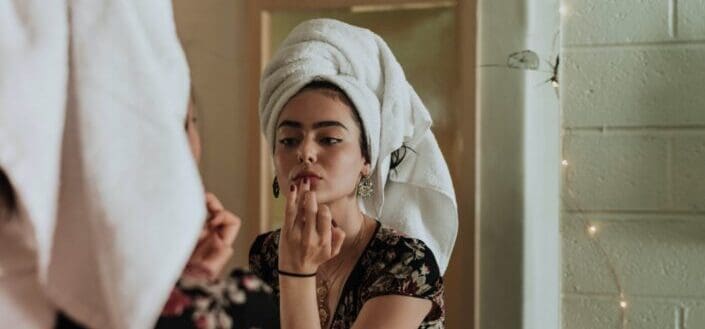woman doing her makeup