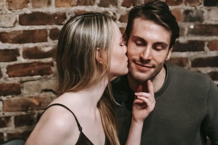 Woman kissing her partner