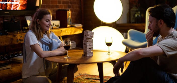 Couple playing Jenga at night.
