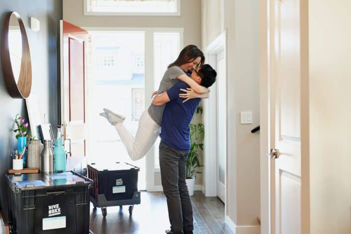 Couple tightly hugging.