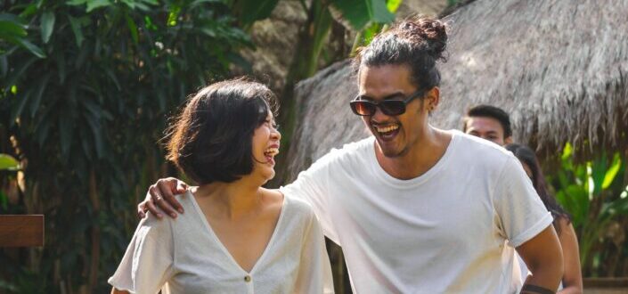 Couple walking through the stone walkway while laughing.