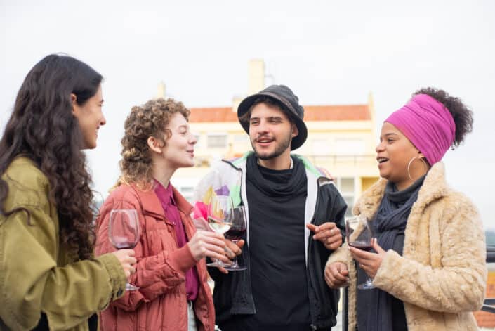 Couple with their friends drinking wine together.