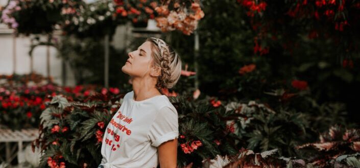 Lady enjoying the breeze while in a garden